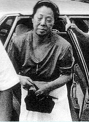 A grainy black and white photo of Japanese business woman Nui Onoue emerging from a car.