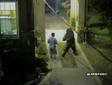 A screenshot from To Catch a Predator where the show's target is leaving the house but about to get tackled by an officer in a ghillie suit