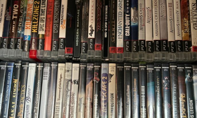 Rows of PlayStation game cases are neatly arranged side-by-side.
