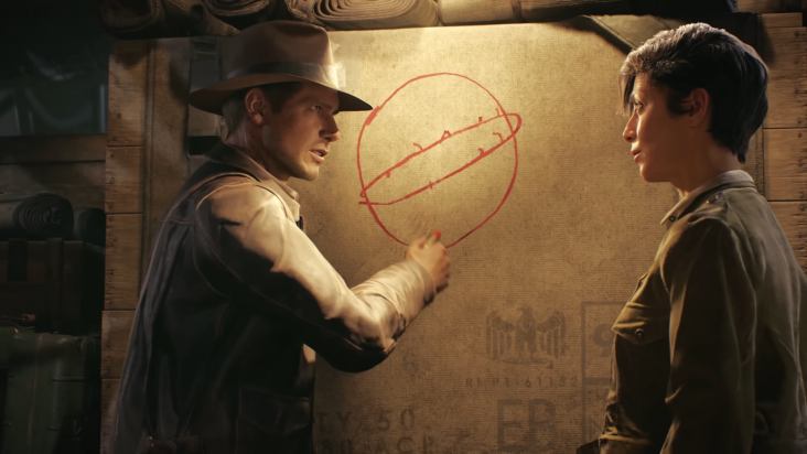Indiana Jones draws a diagram on a bulletin board while speaking to a young man.