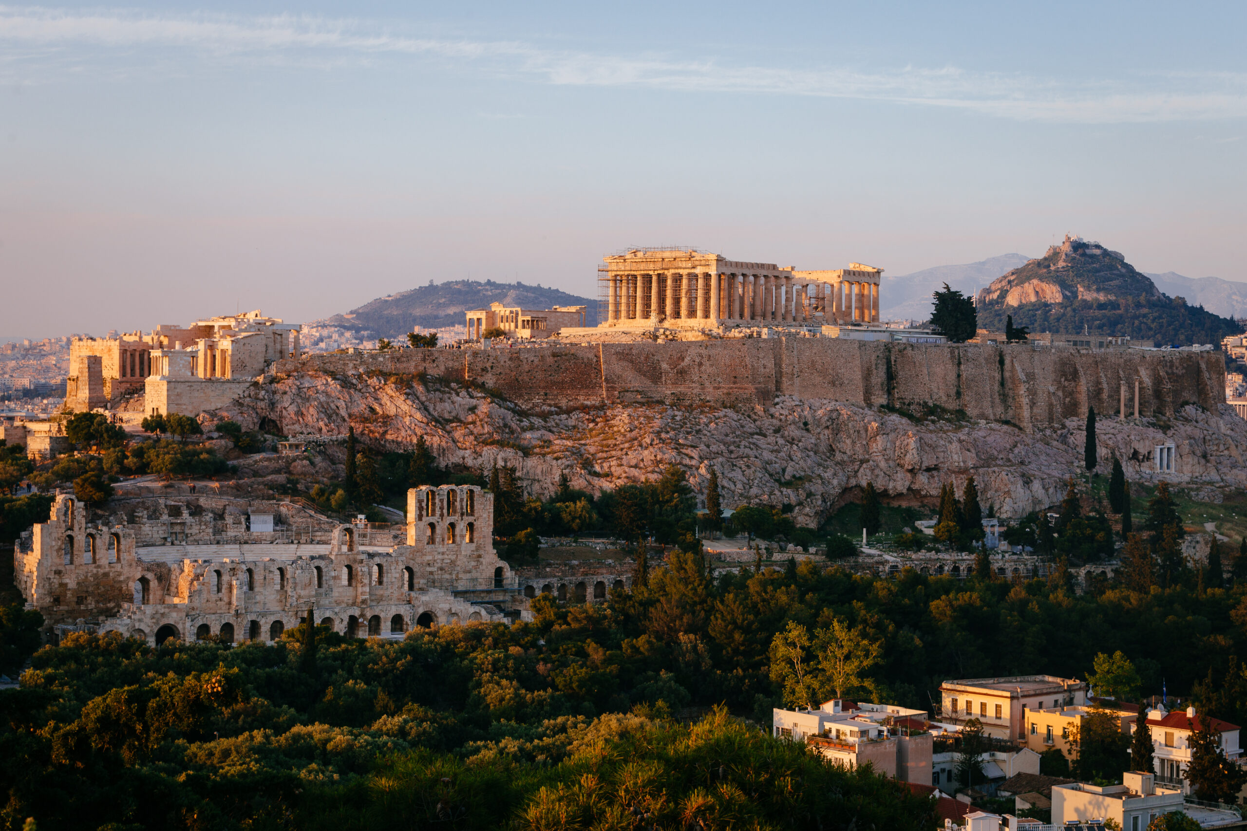 More Athenian ruins situated on a cliff at golden hour.