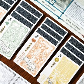 A photograph of some cards and info sheets for Molly house, the cards have intricute woodcut like drawings of acharacters dancing, listening to music, singing baudy songs and gossiping all the way