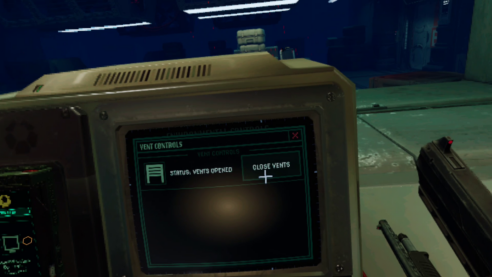 An in game-screenshot for Alien Rogue Incursion where the player is using a computer while holding a gun and keeping an eye on a suspiciously empty warehouse