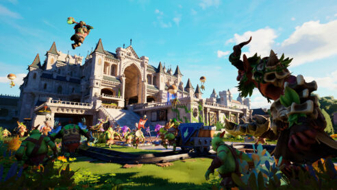 A screenshot from Orcs Must Die Deathtrap on the lawn of a fancy European palace swarmed with orcs with banners, axes, riding balloons, just causing all sorts of zaniness