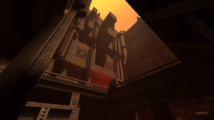 A forced perspective shot of a blocky metal structure in Quake II, the distant sky glowing a hellish orange.