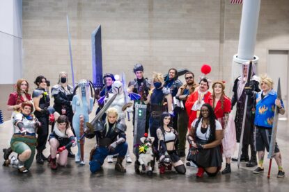 Another photograph of Final Fantasy VII and more cosplayers with colorful hair, giant swords, mashup costumes and L E D lights