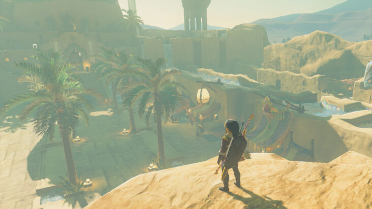 Link stands on a rocky outcropping overlooking the central market plaza of Gerudo Town.