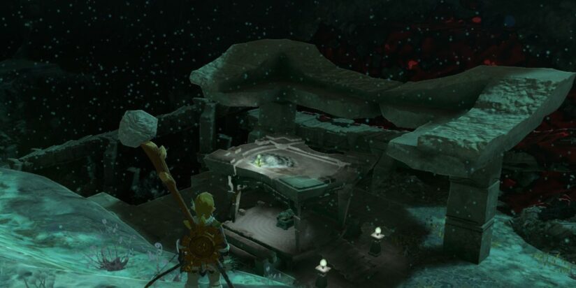 Link stares down at the ruins of a stone structure, perhaps a temple, in a screenshot from Tears of the Kingdom.