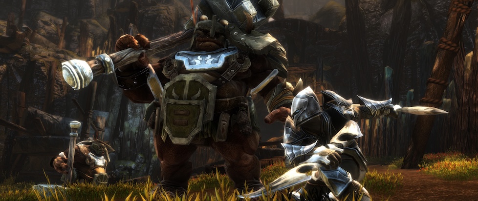 A screenshot from Kingdom of Amalur, a large orc in metal armor wielding a huge hammer is facing off a character in heavy armor with who knives but the orc doesn't look worried about it