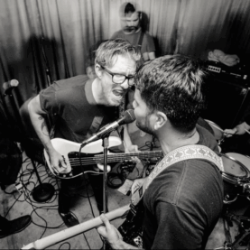 Beau Navire rocks out in a black-and-white photo from a gig.
