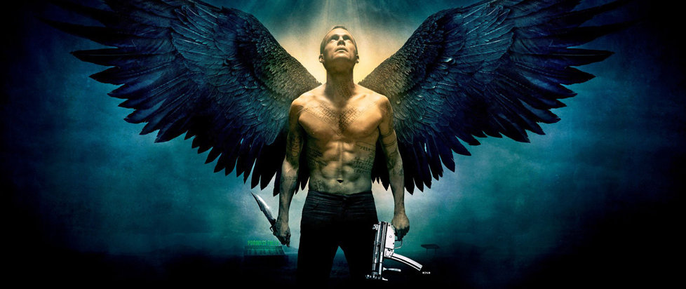 Official art for the film Legion shows a shirtless archangel Michael gazing upwards into a beam of light, wings outstretched.