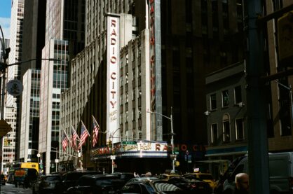 A photograph Matthew took on the Nikon F80 of Radio Music Hall's sign in New York City With bright light and dark shadows covering all the buildings