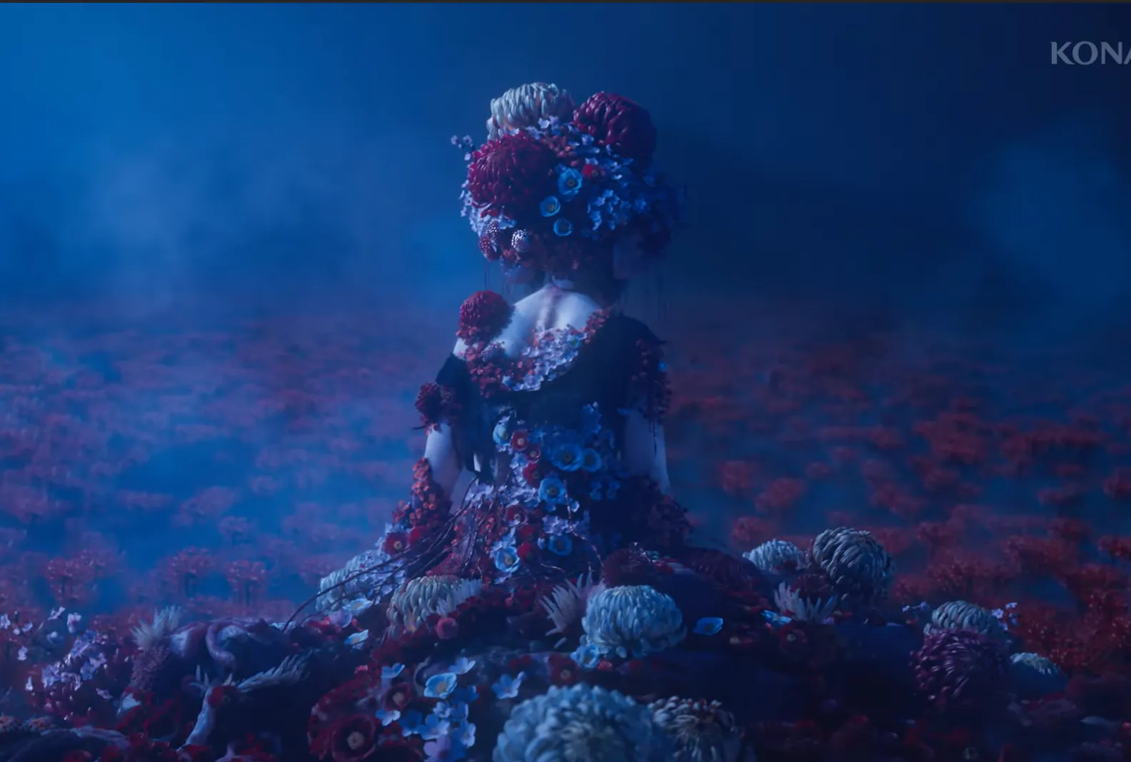 A screenshot from Silent Hill f shows a woman sitting in a dark place, absolutely covered in flowers and other growing things.