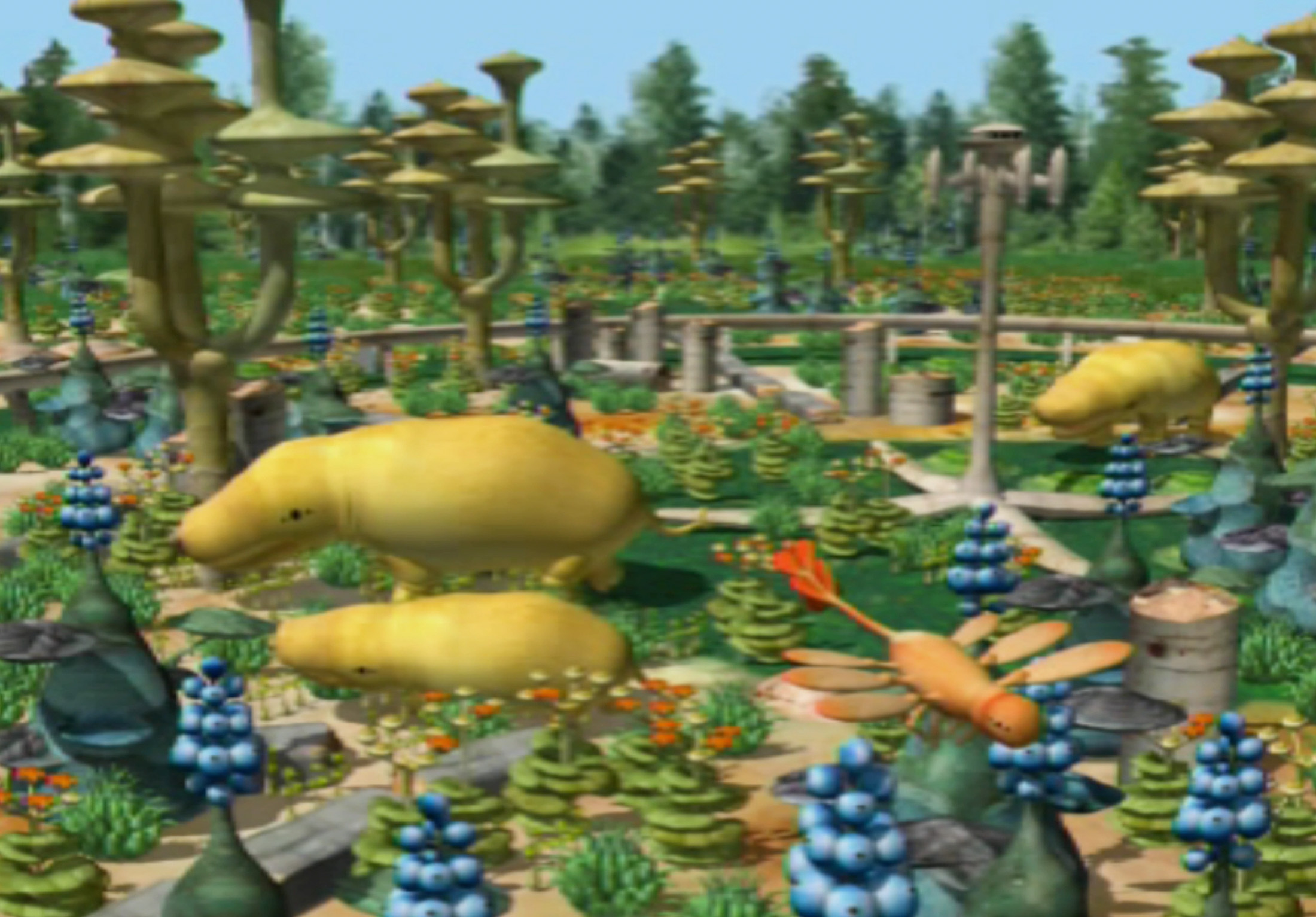 A screenshot from L.O.L. shows a colorful, alien-like landscape filled with fantastical plants and creatures.