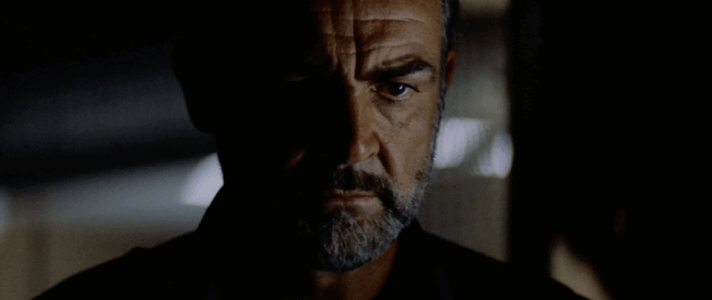 a screenshot for the trailer for Outland with a pensive Sean Connery staring down with a furrowed brow and a dark moustache