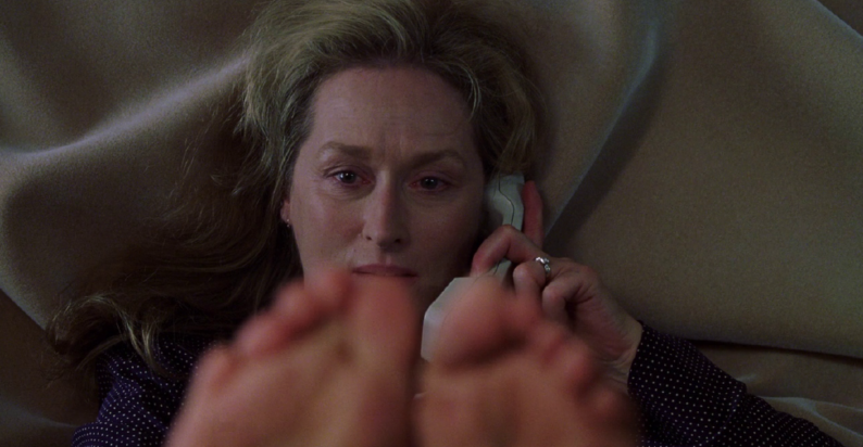 Another still from Adaptation has Meryl Streep lying back on a bed with a phone against her ear, examining her toes.