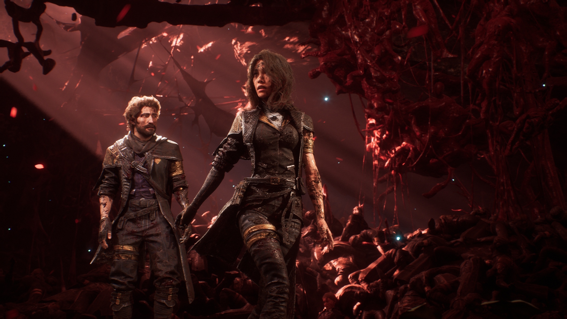 A scene from Clair Obscur: Expedition 33 depicts two main characters standing in a dark, cavernous environment illuminated primarily by a beam of light and a pervasive red glow.