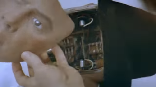 A screenshot from the Westworld trailer where a robot is having their face taken off but the hat remains the hat always remains