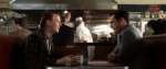 A screencap from Mad Men where Don and his brother are in a diner at a booth facing each other but Don doesn't look happy