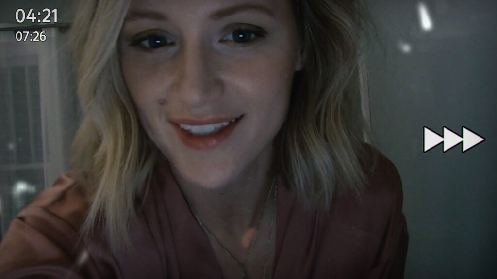 A woman with blonde hair smiles at a webcam. Video interface elements are visible, including timestamps "04:21" and "07:26" in the top left corner, and a fast-forward icon on the right side of the screen.