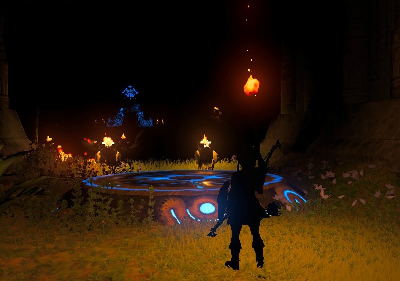 The player character Link is silhouetted, standing in tall grass near a glowing blue circular platform on the ground. Several small fires and glowing structures barely illuminate the pitch-black environment.