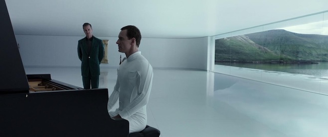 A screenshot from Alien Covenant where one of Fassbender's androids is dressed in white and playing a piano in a large stark white room facing the landscape and someone in a suit standing nearby