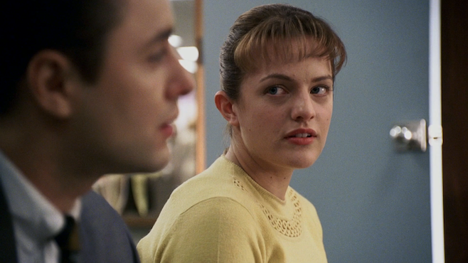 A screenshot of Mad Men where Peggy and Peter are having a conversation and she's looking at him with desire and admiration and he's telling some story