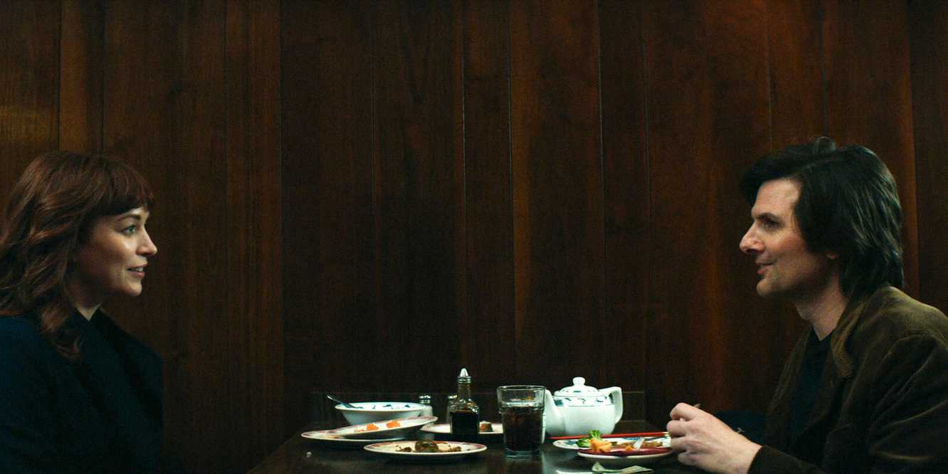 Helena and Mark chat across the table at a diner, all smiles.