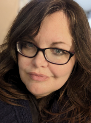 An author photo of tonia laird, a woman with long dark hair wearing rectangular glasses.
