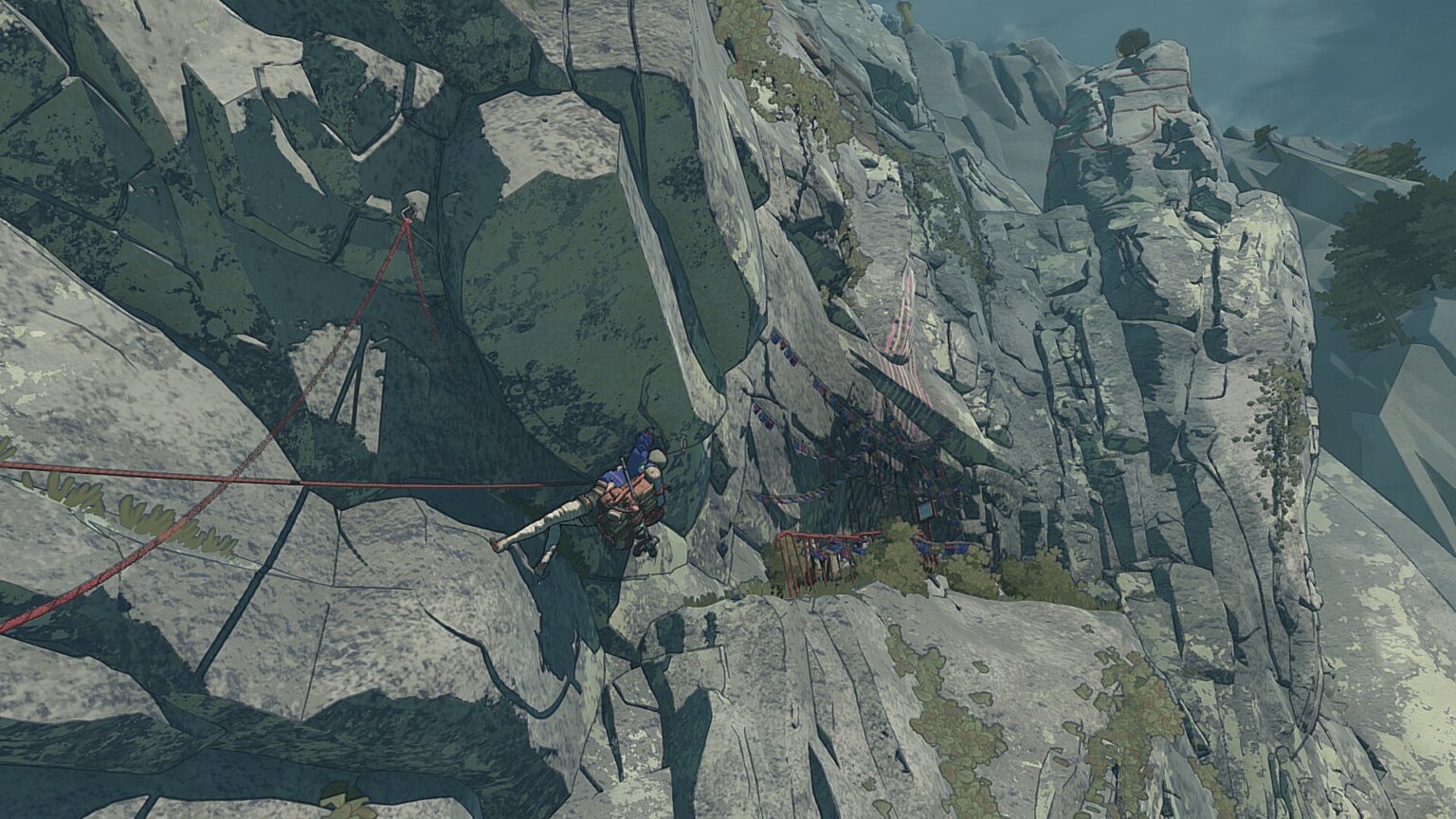 Aava shimmies sideways to a nearby cliff ledge using a series of red ropes.