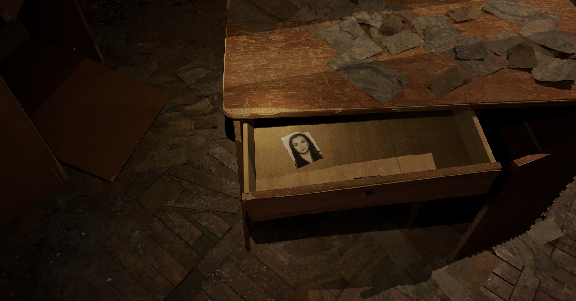 A dilapidated desk has a partially opened drawer. Inside is a tiny black-and-white passport-style photo of a woman gazing directly at the camera.