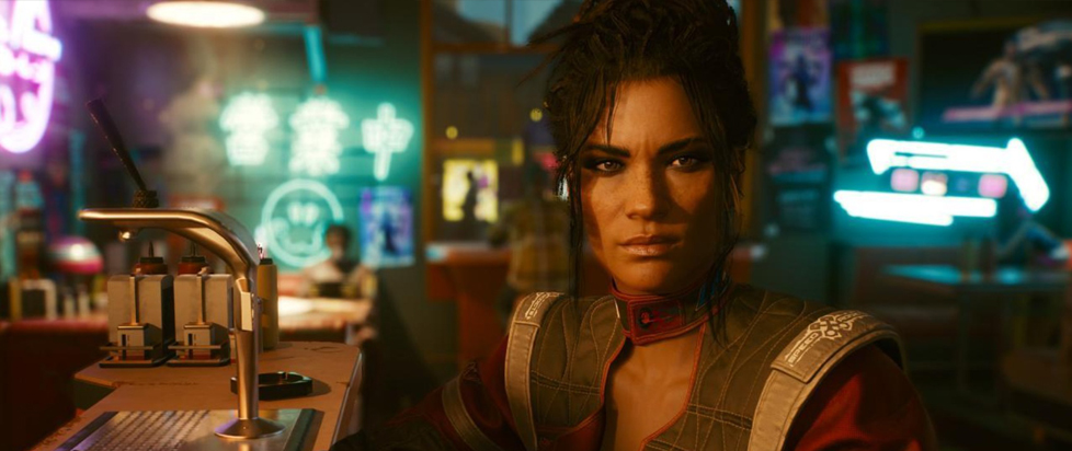 A screenshot from Cyberpunk 2077 shows NPC Panam Palmer in a neon-lit bar setting. Her dark hair is piled on her head and she has a look of concerned annoyance.