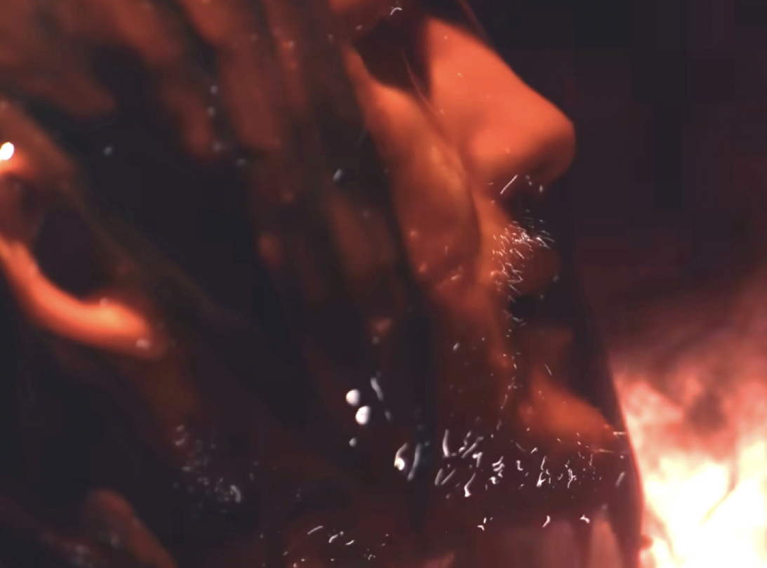 Another close-up of Markiplier, this time in side profile and lit with a sinister red light.