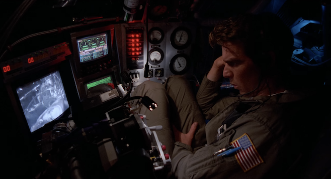 A screenshot of Innerspace where Quad is cooped up in his tiny sub watching what Martin's up to on his monitor