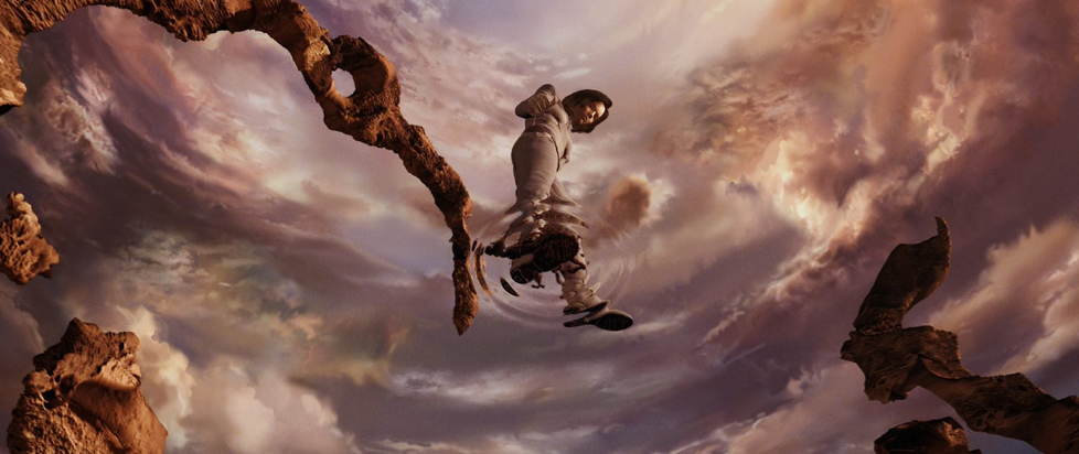 A scene from Final Fantasy: The Spirits Within shows a sequence where Aki Ross dreams she's walking on a crystal pool of water. Behind her, the sky's ablaze in pinks.