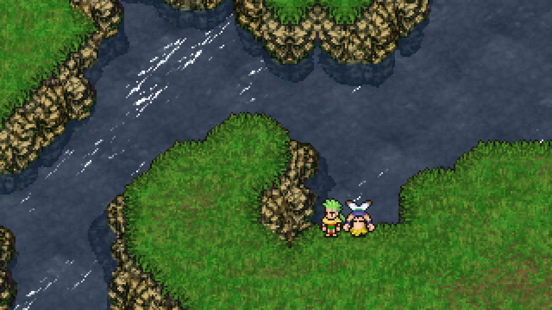 A bird's-eye view of a classic 2D pixel art scene from Final Fantasy VI. Two character sprites, one with green hair and an orange outfit and the other with a blue and white winged hat, stand on a vibrant green grassy peninsula bordered by dark blue water.